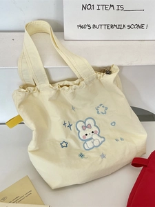 Cute beige canvas drawstring tote bag with embroidered rabbit and stars for daily use