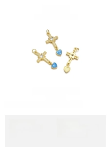 Detail of 18K gold plated heart cross pendant with blue opal and cubic zirconia