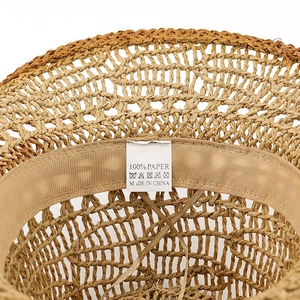 Detail of hand-woven paper straw hat showing internal sweatband and breathable hollow mesh