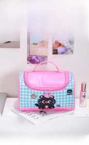 Blue and pink plaid cosmetic bag detail with cute cat pattern and top handle design