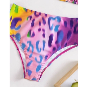 Detailed view of high-waisted bikini bottoms with colorful rainbow leopard print pattern