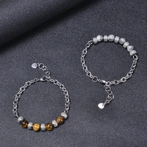 Detail of beaded men's bracelets with brown tiger eye stone and stainless steel links