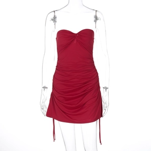 Detail of red strapless mini dress featuring ruching textures and side drawstrings