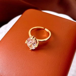 Macro view of a gold-plated ring featuring a sparkling oval-shaped zircon gemstone.