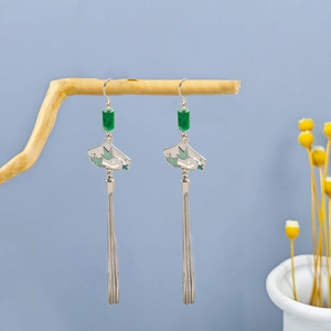 Close-up of vintage Chinese style long tassel bamboo leaf earrings with green beads