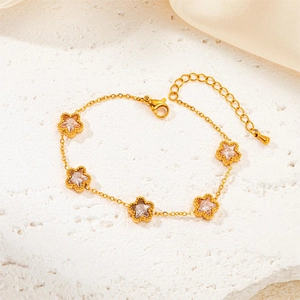 Elegant gold titanium steel bracelet with star charms and sparkling emerald zircons