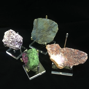 Detailed view of mineral stones on transparent acrylic bases with metal wire supports