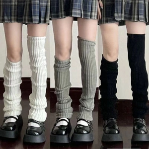 Knit leg warmers in white, grey, and black, featuring ribbed texture for Y2K style