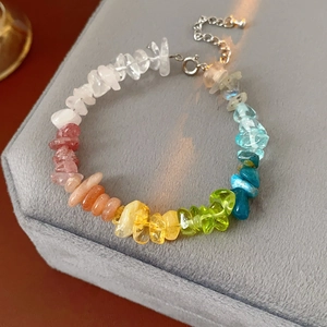 Close-up of rainbow natural stone beaded bracelet with silver spring clasp and chain