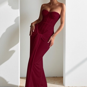 Detail of burgundy evening gown showing strapless neckline and floral lace bodice texture