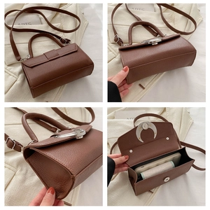 Détails du sac à main marron en cuir grainé avec boucle en croissant argentée et intérieur