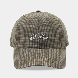 Detail of white Done embroidery on brown checkered baseball cap with visible stitching