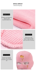 Detail view of pink knitted ski mask featuring embroidered yellow rose and inner texture
