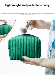 Detail of green quilted velvet makeup bag with gold zipper and vertical stitching