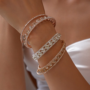 Close-up of three-layer zircon bracelets set on wrist featuring silver and rose gold finish