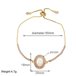 Detail of adjustable gold bracelet featuring Virgin Mary pendant and pink zircon stones