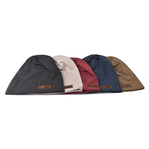 Close-up of knit beanies in multiple colors with leather logo patch and ribbed texture