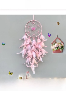 Detailed view of pink dream catcher with soft gradient feathers and butterfly accents