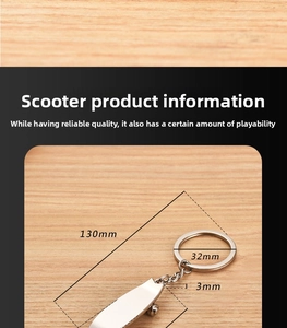 Macro shot of silver metal skateboard keychain showing 130mm total length and 32mm ring size
