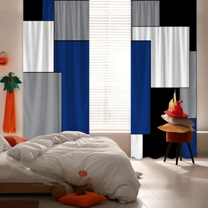 Detail of modern geometric patchwork curtains in blue, white and grey polyester fabric