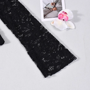 Close-up of black lace fabric with delicate floral hollow patterns and mesh texture