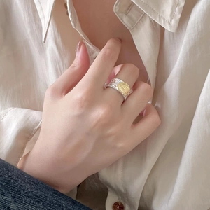 Detailed view of retro 925 sterling silver ring with gold medallion on hand