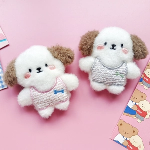 Cute handmade wool felt puppy pins in pink and grey plaid vests on pink background