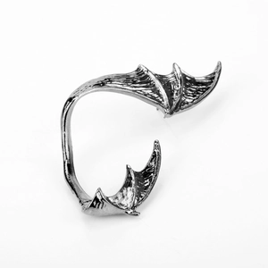 Detailed view of vintage silver bat wing ear cuff with intricate metallic texture