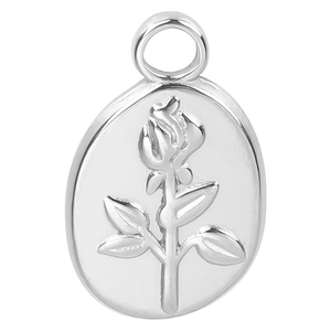 Detailed close-up of a silver oval metal pendant with a 3D embossed rose flower design