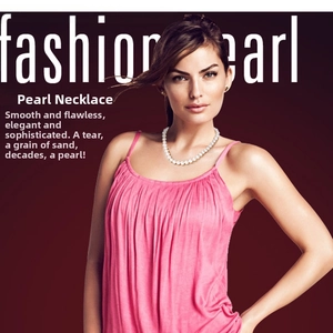 Elegant white pearl necklace showcased on model with a soft red gradient background