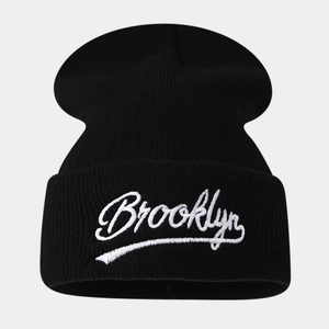 Close-up of white Brooklyn embroidery on black knit beanie with cuff detail