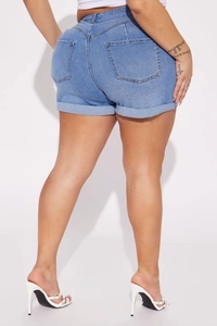Rear view of plus size high-waist light blue denim shorts with rolled hems and pockets
