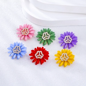 Set of six colorful daisy pins with vibrant enamel petals and sparkling crystal centers