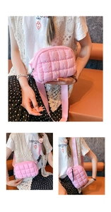 Detailed view of pink quilted puffer fanny pack with wide nylon strap and zipper