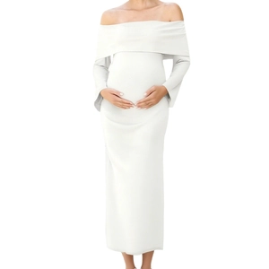 Detail of off-shoulder neckline and stretch knit fabric on this white maternity maxi dress