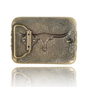 Vintage western cowboy belt buckle with embossed longhorn skull and floral scroll pattern