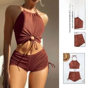 Detail view of brick red halter bikini set featuring front metal ring and side drawstring