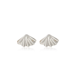Macro detail of fan-shaped silver earrings with textured metallic shell pattern