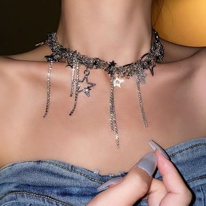Close-up of silver star tassel necklace with sparkling rhinestones on model neck