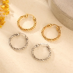 Vintage twisted hoop earrings in gold and silver finish with high polished metal shine
