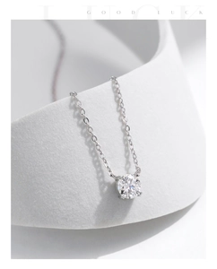Detail of s925 silver necklace featuring a four-prong set round brilliant moissanite stone