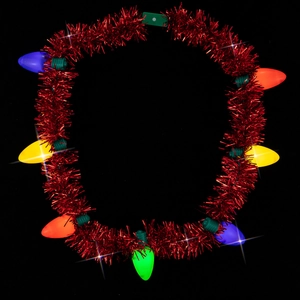 Close-up of a festive Christmas necklace with colorful glowing bulbs on a red tinsel