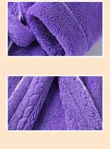 Close-up of purple coral fleece robe with white piped cuffs and reinforced stitching