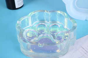 Macro shot of iridescent cat paw resin mold tray with vibrant holographic finish details
