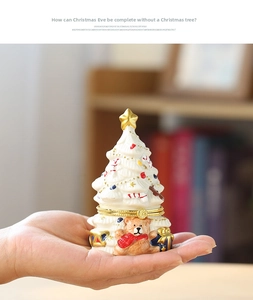 Detailed view of hand-held Christmas tree ceramic jewelry box with cute bear relief