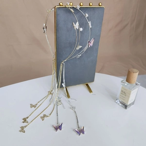 Detailed shot of gold and silver butterfly headbands with long tassels and pearls