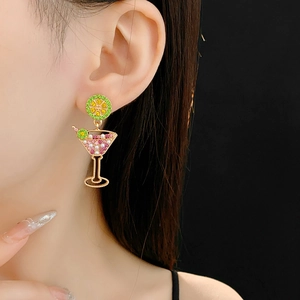 Close-up of vintage gold cocktail glass earring with pearls and colorful crystals