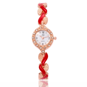 Detail of rose gold quartz watch with red enamel accents and crystal embellishments