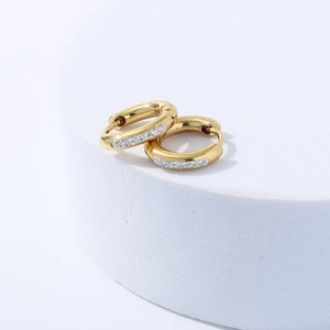 Sparkling gold stainless steel hoop earrings with diamonds on a white platform