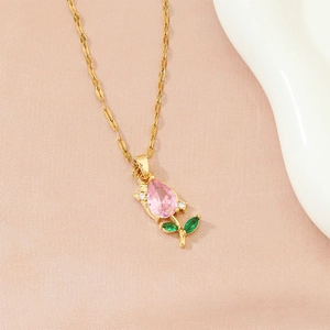 Elegant gold necklace with pink tulip zircon pendant and green leaf accents